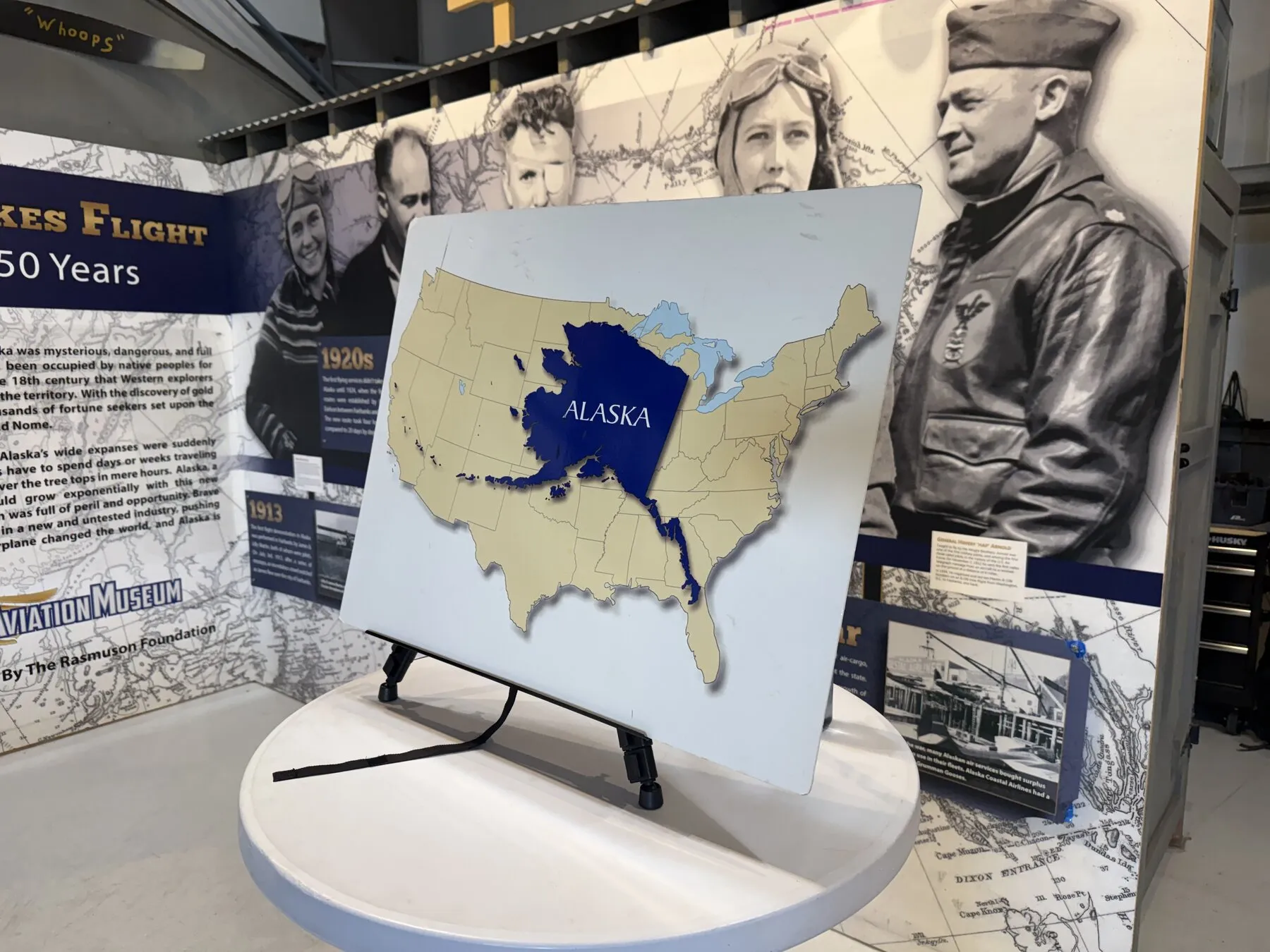 An aviation history exhibit with a map comparing Alaska and the contiguous United States