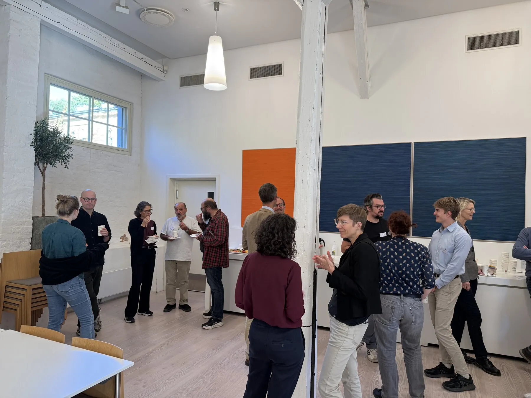 Summit participants talking in small groups around the room