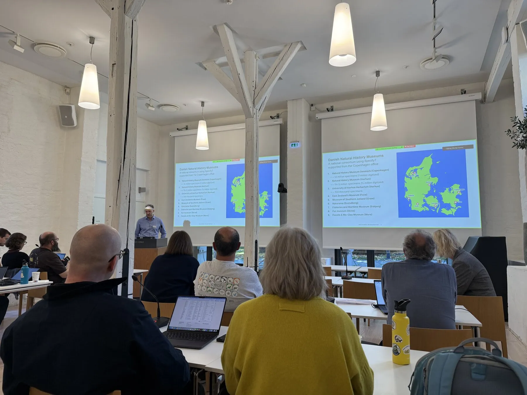 A summit presentation showing maps of the European Specify community