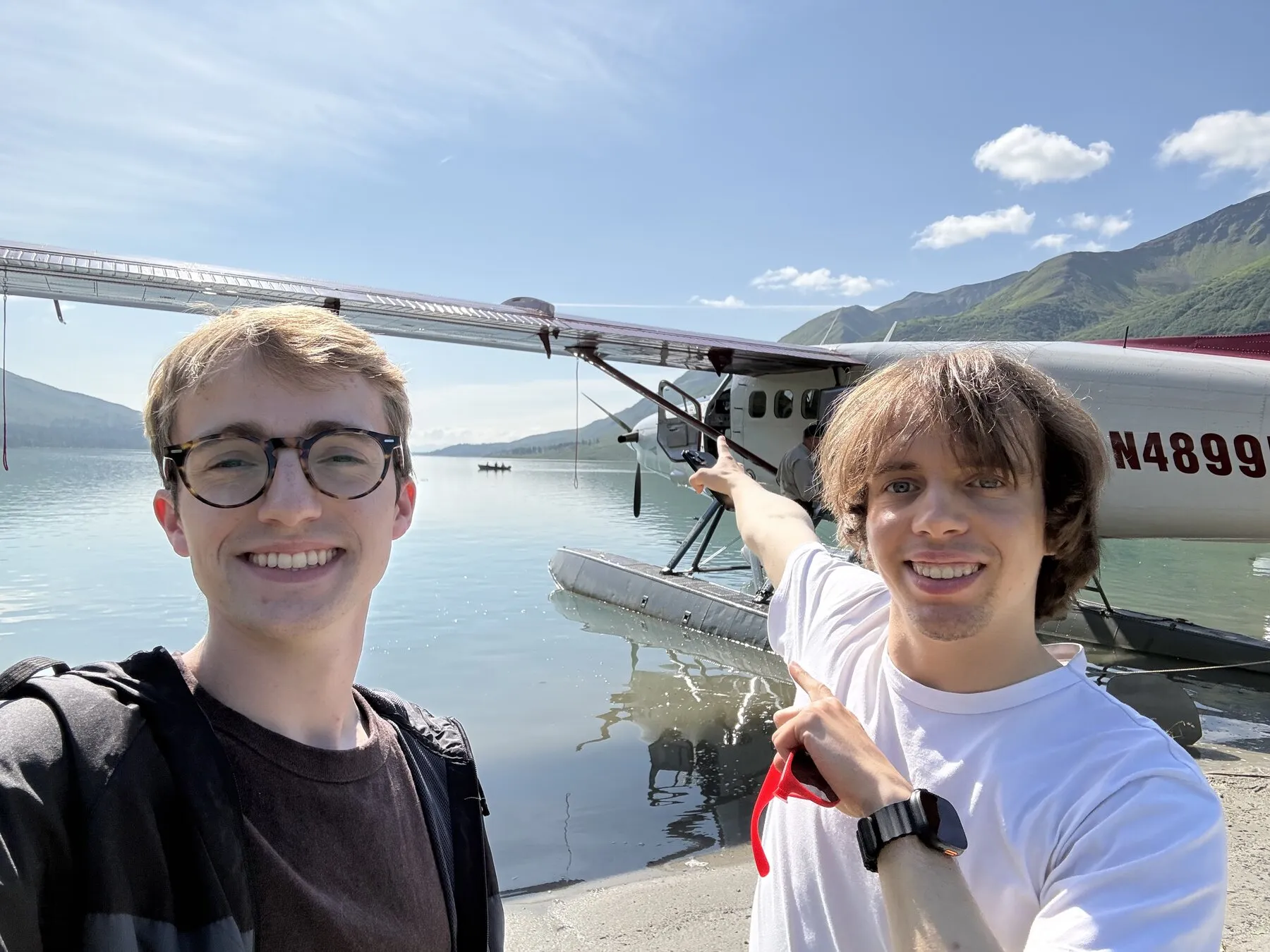 Us beside the floatplane with the lake and mountains behind them