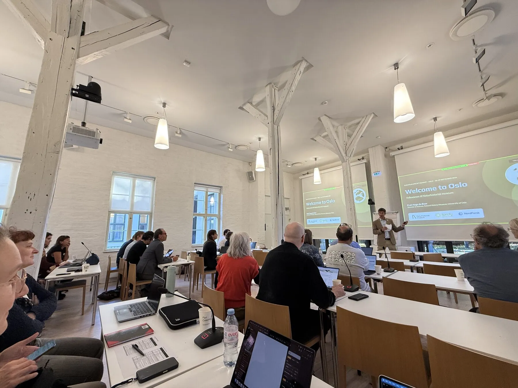 Participants listening to a presentation in the bright summit meeting room